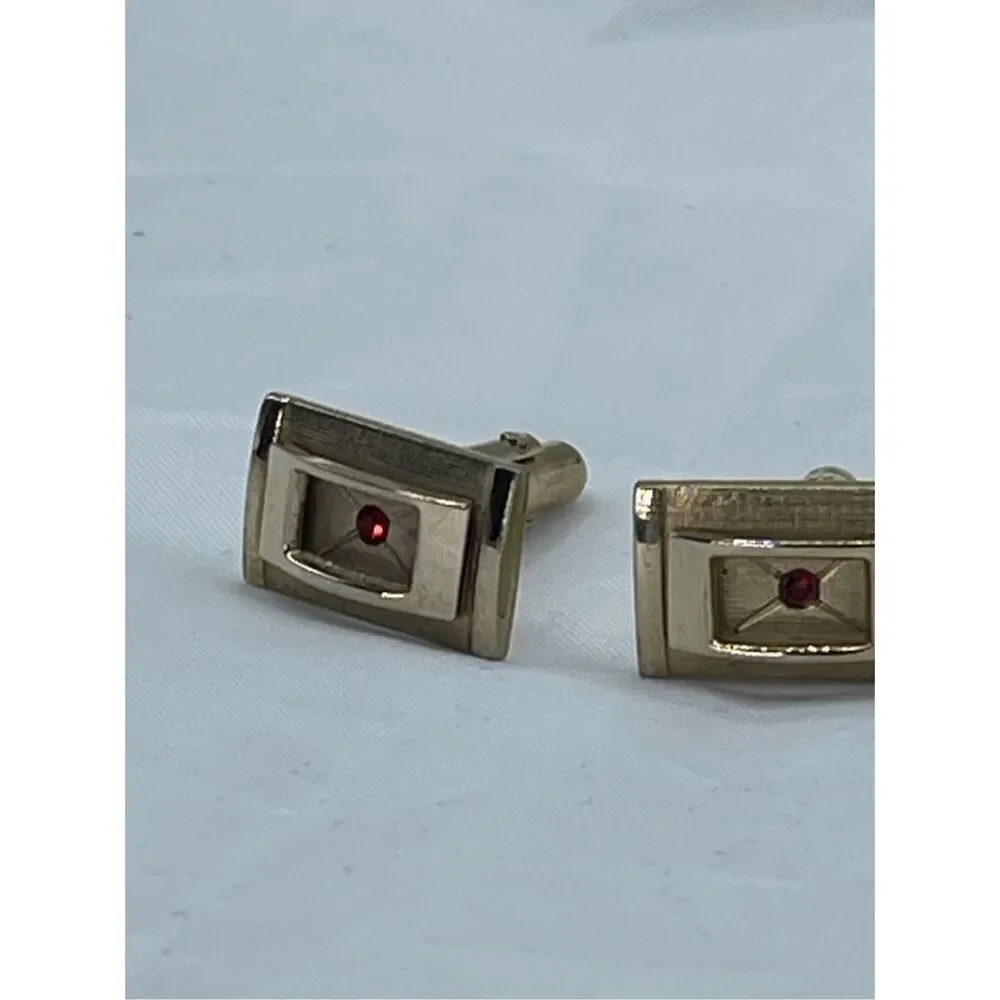 Vintage gold tone cufflinks with cut red glass crystals
